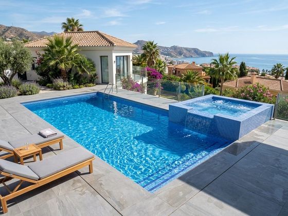 Piscina de obra con zona de spa integrada y desbordante en una villa de la Costa del Sol